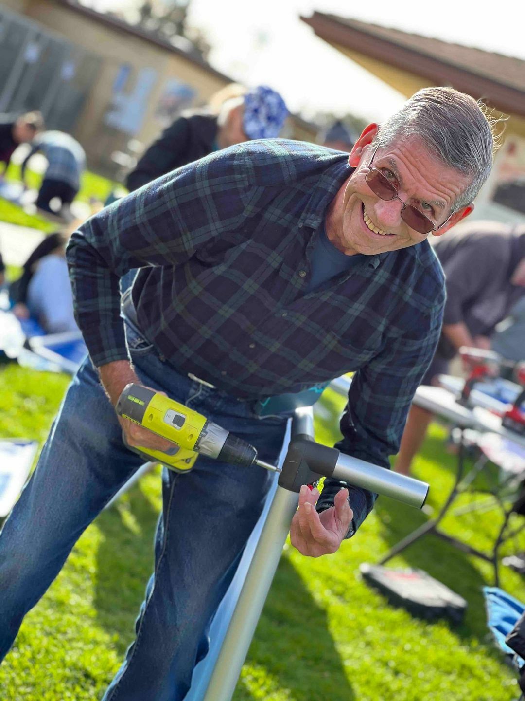 Volunteer assembling Anodized Aluminum Kuranda Bed during massive fundraiser