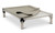 Oatmeal color fleece accessory pad shown on top of a pvc bed, the pad is held to the bed by elastic straps that hook each the legs of the bed. One corner is detached and folded over to show the underside.
